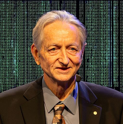 A portrait of an older man with gray hair, wearing a black suit, gray shirt, and patterned tie, standing in front of a digitally edited background. The backdrop features cascading green binary code reminiscent of "The Matrix," symbolizing data and technology. The man is smiling slightly and wearing a small lapel pin, suggesting a formal or prestigious event. The image merges realism with a high-tech, conceptual aesthetic.