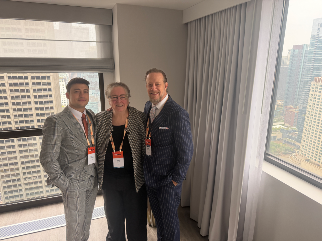 Three EDRM attendees at EDRM's Straggler's Lunch, smiling as they take a photo.